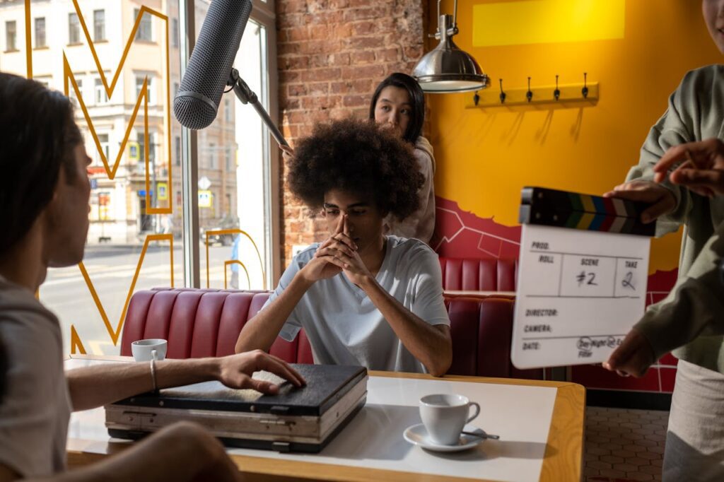 Shooting a scene for a movie in a cafe as the cast and crew get ready for filming.